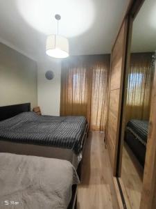 a small bedroom with two beds and a mirror at Tbilisi Dirsi Complex in Tbilisi City