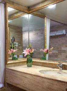 a bathroom with a large mirror and a sink at Meliá Puerto Vallarta in Puerto Vallarta