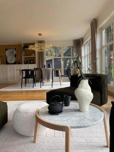 a living room with a couch and a table at Lake House in Vossevangen +48 photos
