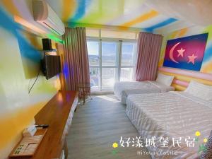 a hotel room with two beds and a television at Hi Young Castle in Hengchun South Gate