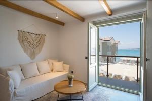 a living room with a couch and a view of the ocean at Carpe Diem Boutique Hotel - Adults Only in Side +64 photos