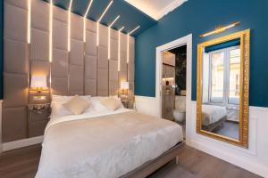 a bedroom with a large bed and a mirror at Lary's - San Pietro in Rome