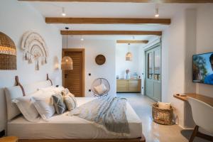 a bedroom with a large white bed with pillows at Carpe Diem Boutique Hotel - Adults Only in Side