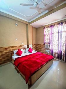 a bedroom with a large bed with red sheets at Hotel Ishaan International Near Yatra Parchi Counter 2 in Katra