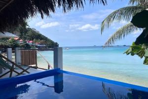 a view of the ocean from a beach with a fence at Anchovy Beachfront Villas in Phú Quốc