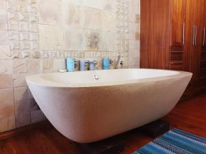 a large white bath tub in a bathroom at Coming Home in Centurion +114 photos