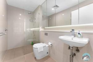 a bathroom with a sink and a toilet and a mirror at Epping 2BR House with Parking in Epping +8 photos