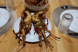 a crab on a plate on a table at Dico Surf Point- Surf Lodge in Simeulue in Lasikin +49 photos