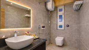 a bathroom with a white sink and a toilet at Yashshree Dewathang Resort in Lachung +58 photos