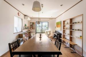 a dining room with a long table and chairs at Blodge Lodge in Wazuka