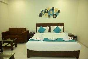 a bedroom with a bed with a clock on the wall at Hotel Casa Lorven Near Golf Course in Visakhapatnam