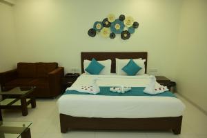 a bedroom with a bed with a clock on the wall at Hotel Casa Lorven Near Golf Course in Visakhapatnam