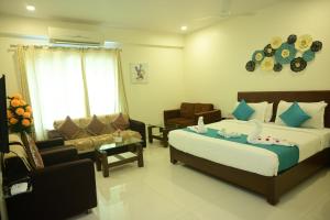 a hotel room with two beds and a living room at Hotel Casa Lorven Near Golf Course in Visakhapatnam