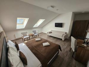 a bedroom with a bed and a living room at Hotel Prague Star in Prague