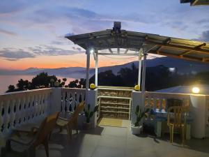 a balcony with chairs and a view of the mountains at Cronin Residences in Oslob