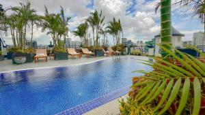a swimming pool on the roof of a building at Caravan Hotel by EHM in Phnom Penh