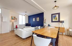 a living room with a table and a couch at Charmante Maison Proche Mer in Royan