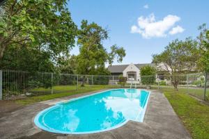 a swimming pool in a yard with a fence at Renall St Gem Central Masterton in Masterton