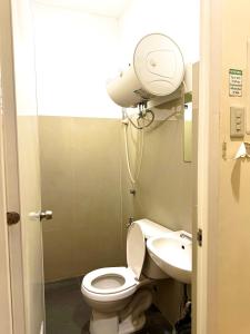a bathroom with a white toilet and a sink at Isla Boracay Inn in Boracay +27 photos