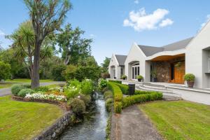 a house with a stream in front of a house at Renall St Gem Central Masterton in Masterton