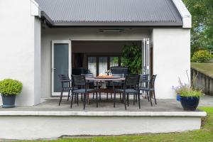 a table and chairs sitting on a patio at Renall St Gem Central Masterton in Masterton