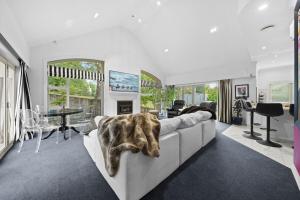 a living room with a couch with a blanket on it at Renall St Gem Central Masterton in Masterton