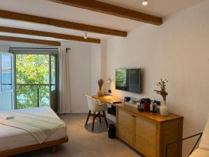 a bedroom with a bed and a desk with a computer at Carpe Diem Boutique Hotel - Adults Only in Side
