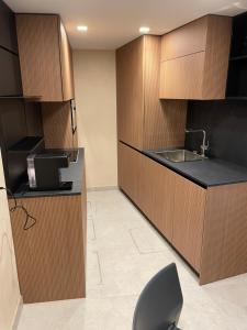 a kitchen with wooden cabinets and a sink and a chair at Ca' San Geremia in Venice