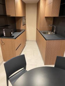a kitchen with a sink and a table with chairs at Ca' San Geremia in Venice +7 photos