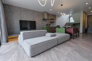 a living room with a couch and a tv at XO Canggu adults only in Canggu