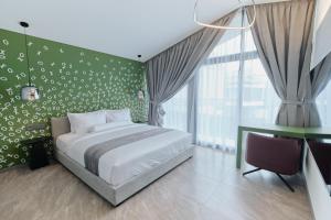 a bedroom with a bed and a green wall at XO Canggu adults only in Canggu +72 photos