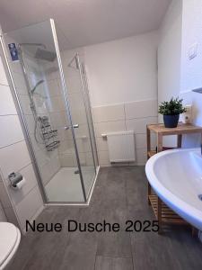 a bathroom with a shower and a sink at Strandläufer in Tossens +7 photos