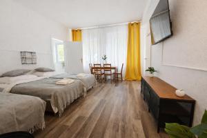 a bedroom with two beds and a table and chairs at Spacious House in Düsseldorf