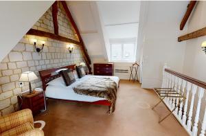 a bedroom with a bed in a room with a staircase at Chateau De Montreuil in Montreuil-sur-Mer +26 photos
