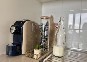 a kitchen counter with a blender and a bottle of milk at Respiro di Tramonto in Montegranaro