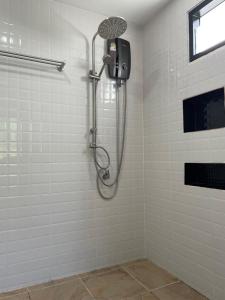a shower with a shower head in a bathroom at Ron Bungalow in Bang Tao Beach