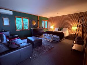 a living room with a bed and a couch at El Grouso in Blenheim
