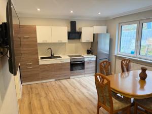 a kitchen with a table and a sink and a refrigerator at Apartment in Otterberg in Otterberg