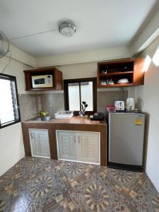 a kitchen with a counter and a refrigerator at Ron Bungalow in Bang Tao Beach +8 photos