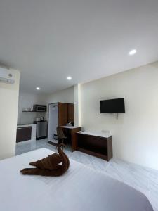 a room with a bed with a wooden snake on it at Ron Bungalow in Bang Tao Beach