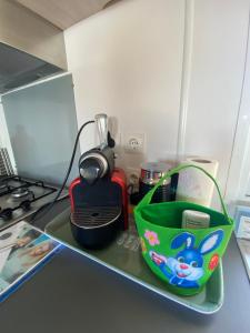 a kitchen counter with a shelf with food and appliances at U paradisu in Lumio