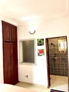 a room with a large screen on the wall at sidof Redence L&A in Yaoundé +3 photos