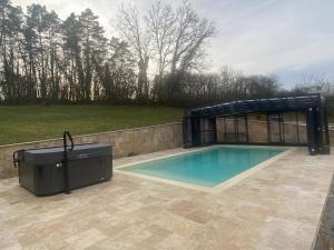 a swimming pool with a gazebo at Vanlodge in Varneil