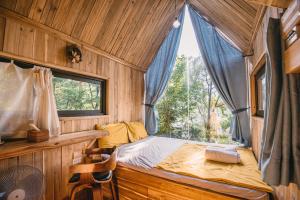 a small bedroom with a bed and a window at U Lesa Retreat - Nhà Bên Rừng in Sóc Sơn +161 photos
