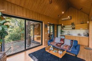 a living room with a couch and a table at U Lesa Retreat - Nhà Bên Rừng in Sóc Sơn