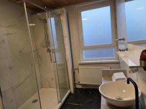 a bathroom with a shower and a sink at Niederdreisbacher Hof in Niederdreisbach +34 photos