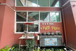 a pink building with a sign on the side of it at P&P Place in Kanchanaburi City