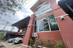 a pink building with a pay phone in front of it at P&P Place in Kanchanaburi City +31 photos