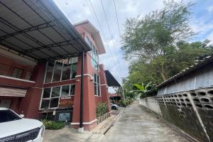 a red building with a car parked in front of it at P&P Place in Kanchanaburi City