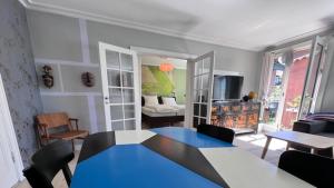 a living room with a blue table and chairs at Deluxe Hotel Apartment in Charlottenlund